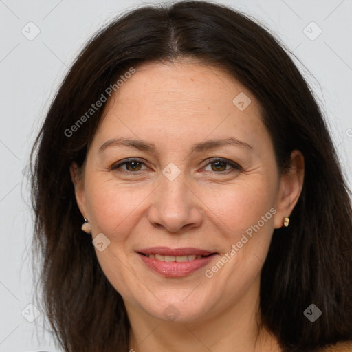 Joyful white adult female with long  brown hair and brown eyes