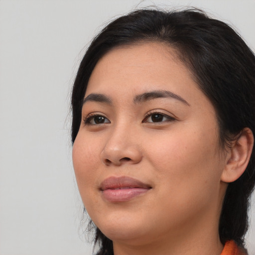 Joyful asian young-adult female with long  brown hair and brown eyes