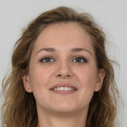 Joyful white young-adult female with long  brown hair and grey eyes