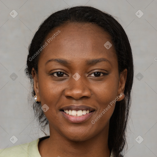 Joyful black young-adult female with long  brown hair and brown eyes