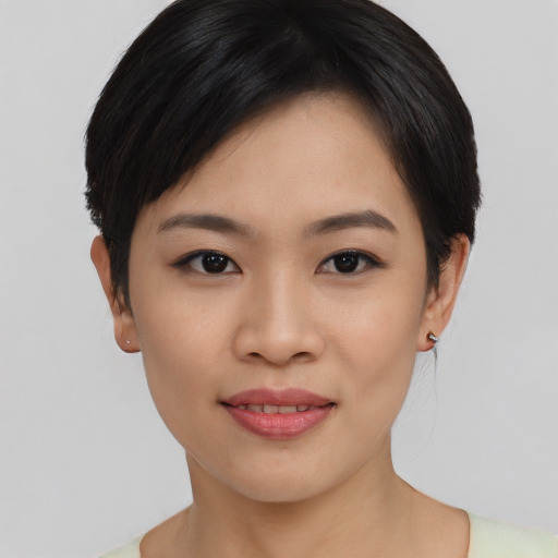 Joyful asian young-adult female with short  black hair and brown eyes