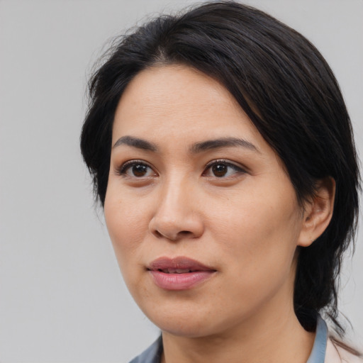 Joyful asian young-adult female with medium  black hair and brown eyes