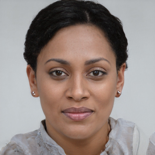 Joyful latino young-adult female with short  brown hair and brown eyes