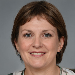 Joyful white adult female with medium  brown hair and brown eyes