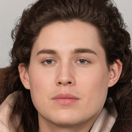 Neutral white young-adult male with long  brown hair and brown eyes