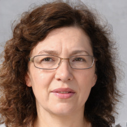 Joyful white adult female with medium  brown hair and blue eyes