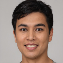 Joyful asian young-adult male with short  black hair and brown eyes