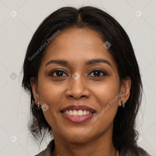 Joyful black young-adult female with long  brown hair and brown eyes