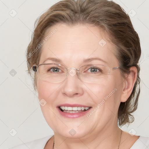 Joyful white adult female with medium  brown hair and blue eyes