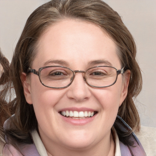 Joyful white adult female with medium  brown hair and blue eyes