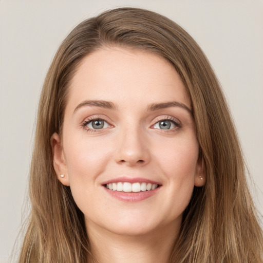 Joyful white young-adult female with long  brown hair and green eyes