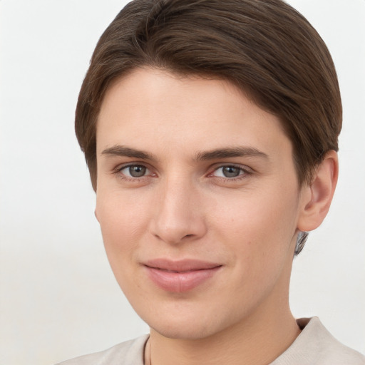 Joyful white young-adult female with short  brown hair and grey eyes