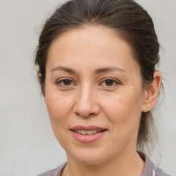 Joyful white adult female with medium  brown hair and brown eyes