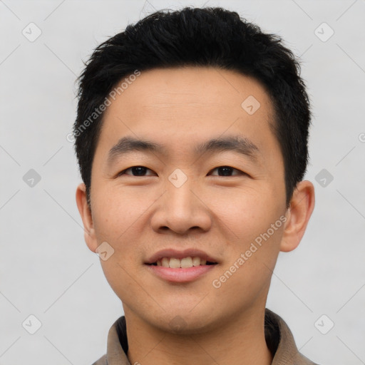 Joyful asian young-adult male with short  black hair and brown eyes