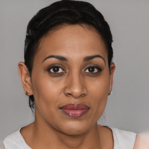 Joyful black young-adult female with short  brown hair and brown eyes