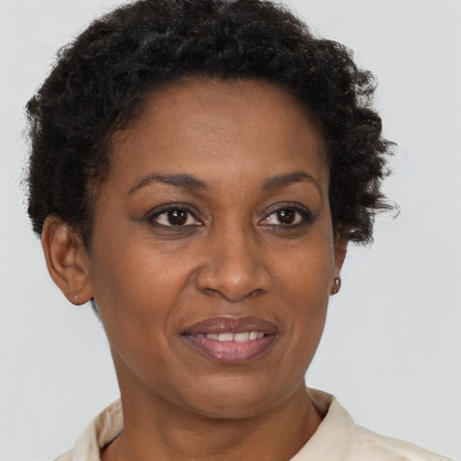 Joyful black adult female with short  brown hair and brown eyes