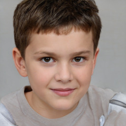 Joyful white child male with short  brown hair and brown eyes