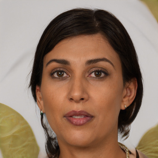 Joyful asian adult female with medium  brown hair and brown eyes