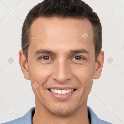 Joyful white young-adult male with short  brown hair and brown eyes