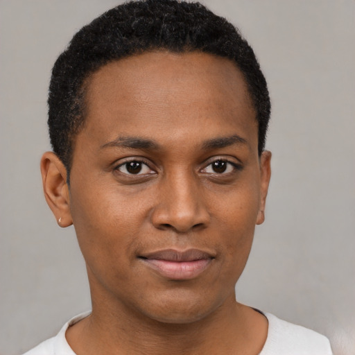 Joyful black young-adult male with short  black hair and brown eyes