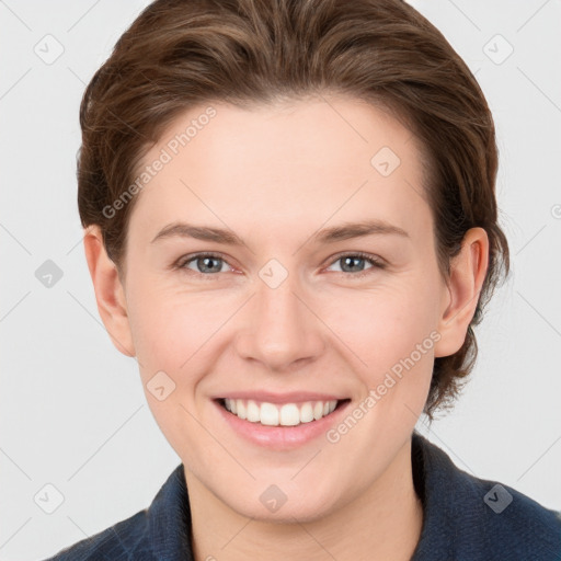 Joyful white young-adult female with short  brown hair and grey eyes