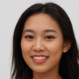 Joyful asian young-adult female with long  brown hair and brown eyes