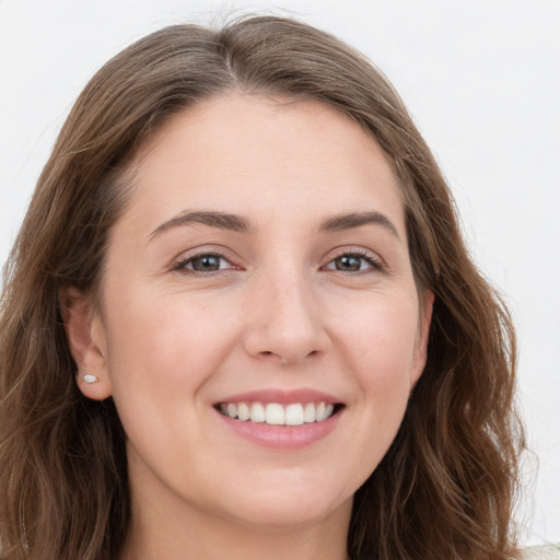 Joyful white young-adult female with long  brown hair and grey eyes