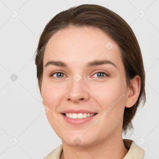 Joyful white young-adult female with medium  brown hair and grey eyes