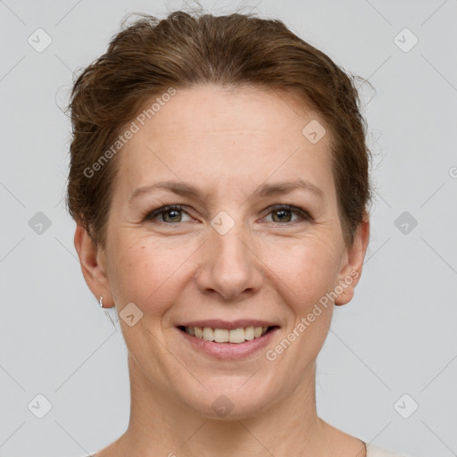 Joyful white adult female with short  brown hair and grey eyes