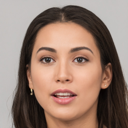 Joyful white young-adult female with long  brown hair and brown eyes