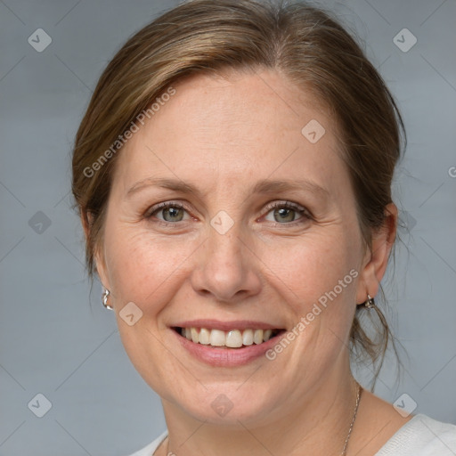 Joyful white adult female with medium  brown hair and grey eyes