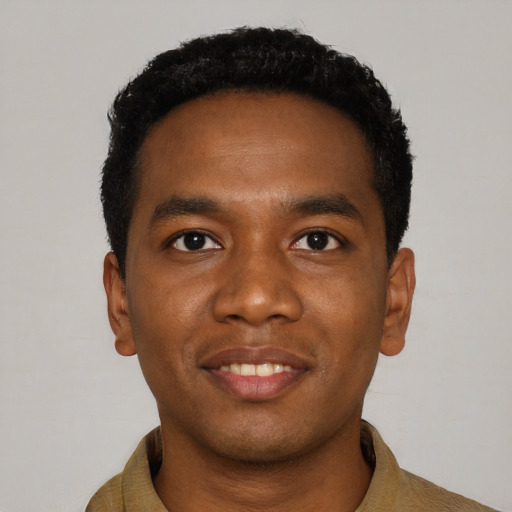 Joyful black young-adult male with short  black hair and brown eyes