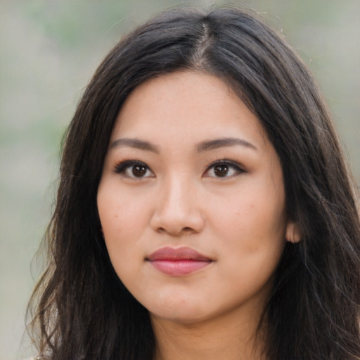 Joyful asian young-adult female with long  brown hair and brown eyes