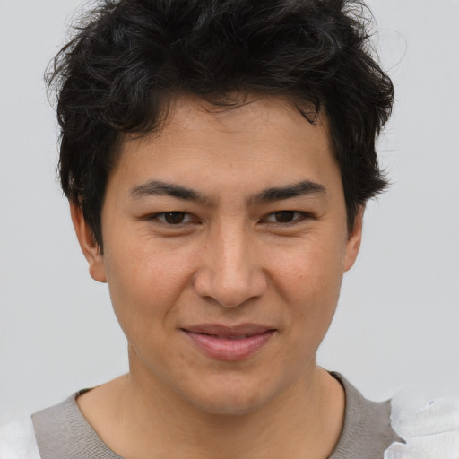 Joyful asian young-adult male with short  brown hair and brown eyes