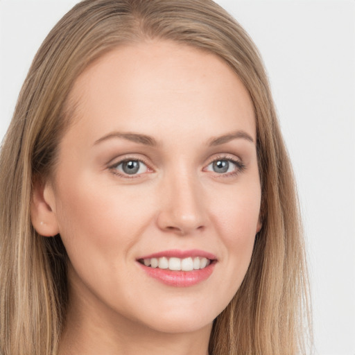 Joyful white young-adult female with long  brown hair and grey eyes