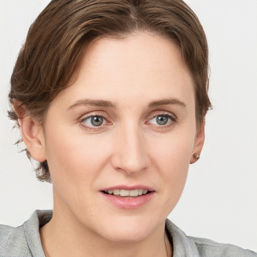 Joyful white young-adult female with medium  brown hair and blue eyes