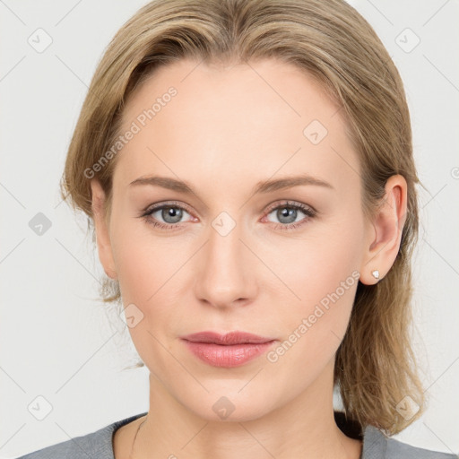 Joyful white young-adult female with medium  brown hair and blue eyes