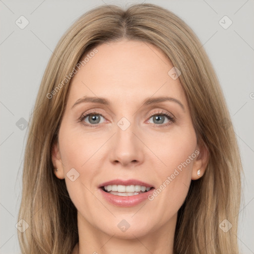 Joyful white adult female with long  brown hair and grey eyes