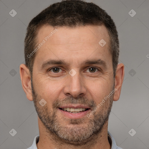 Joyful white adult male with short  brown hair and brown eyes