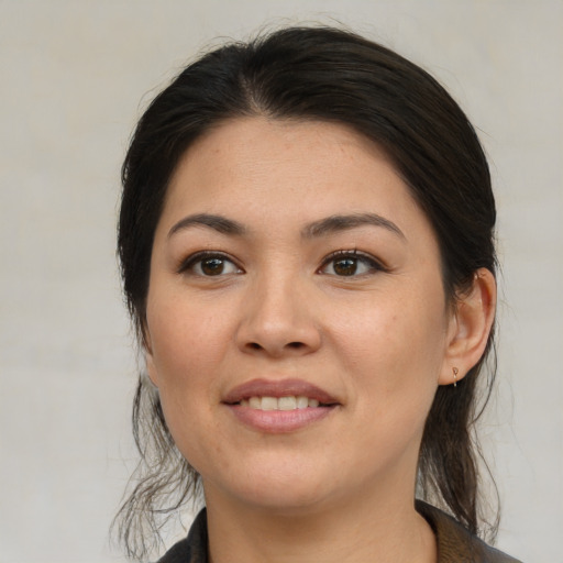 Joyful asian young-adult female with medium  brown hair and brown eyes