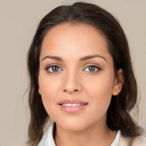 Joyful white young-adult female with medium  brown hair and brown eyes