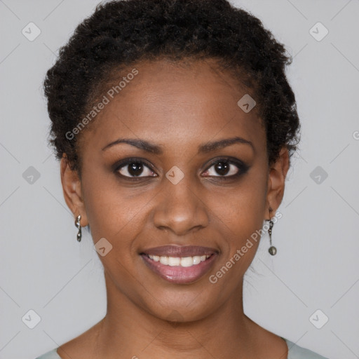 Joyful black young-adult female with short  brown hair and brown eyes