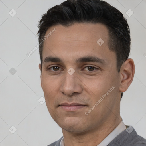 Joyful white young-adult male with short  black hair and brown eyes