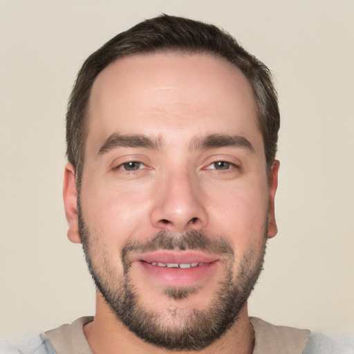 Joyful white young-adult male with short  black hair and brown eyes