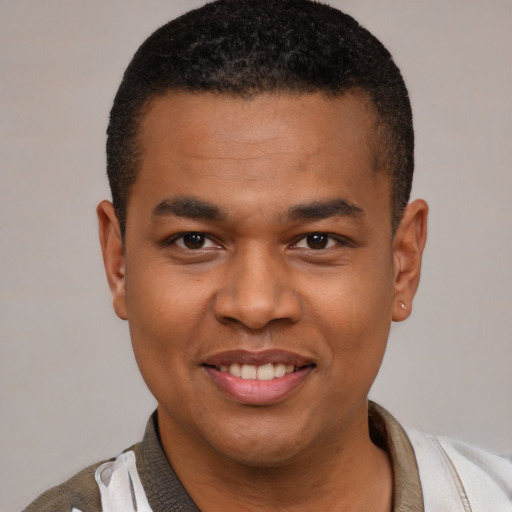 Joyful latino young-adult male with short  black hair and brown eyes