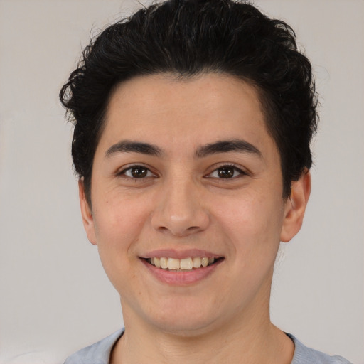 Joyful latino young-adult male with short  brown hair and brown eyes