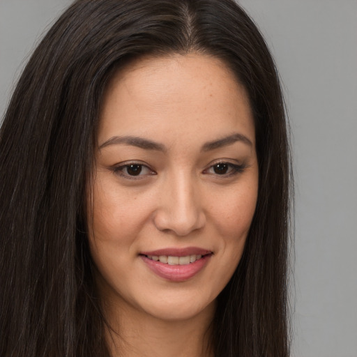 Joyful latino young-adult female with long  brown hair and brown eyes