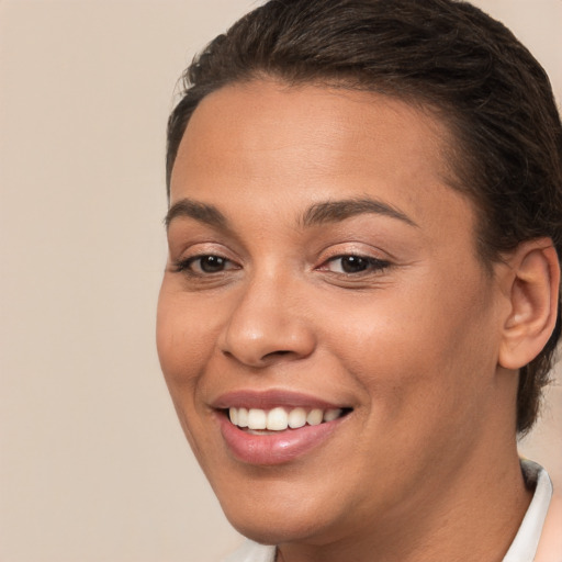 Joyful white young-adult female with short  brown hair and brown eyes