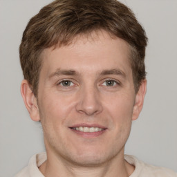 Joyful white adult male with short  brown hair and grey eyes