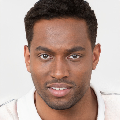 Joyful black young-adult male with short  brown hair and brown eyes